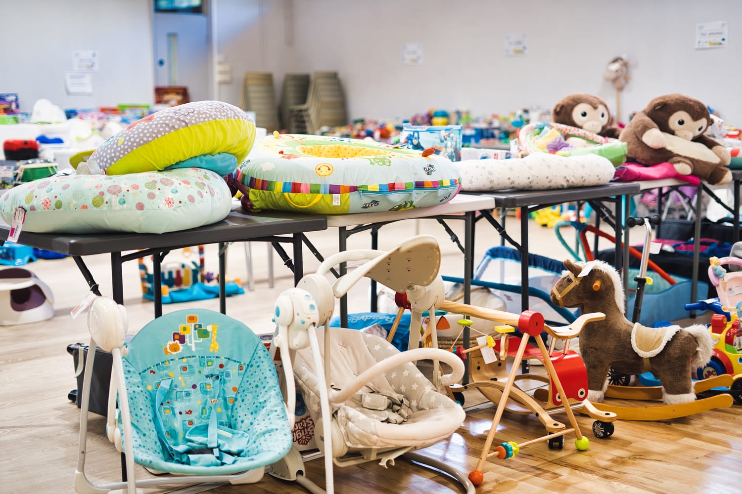 Baby chairs and cuddly toys at an NCT Nearly New Sale