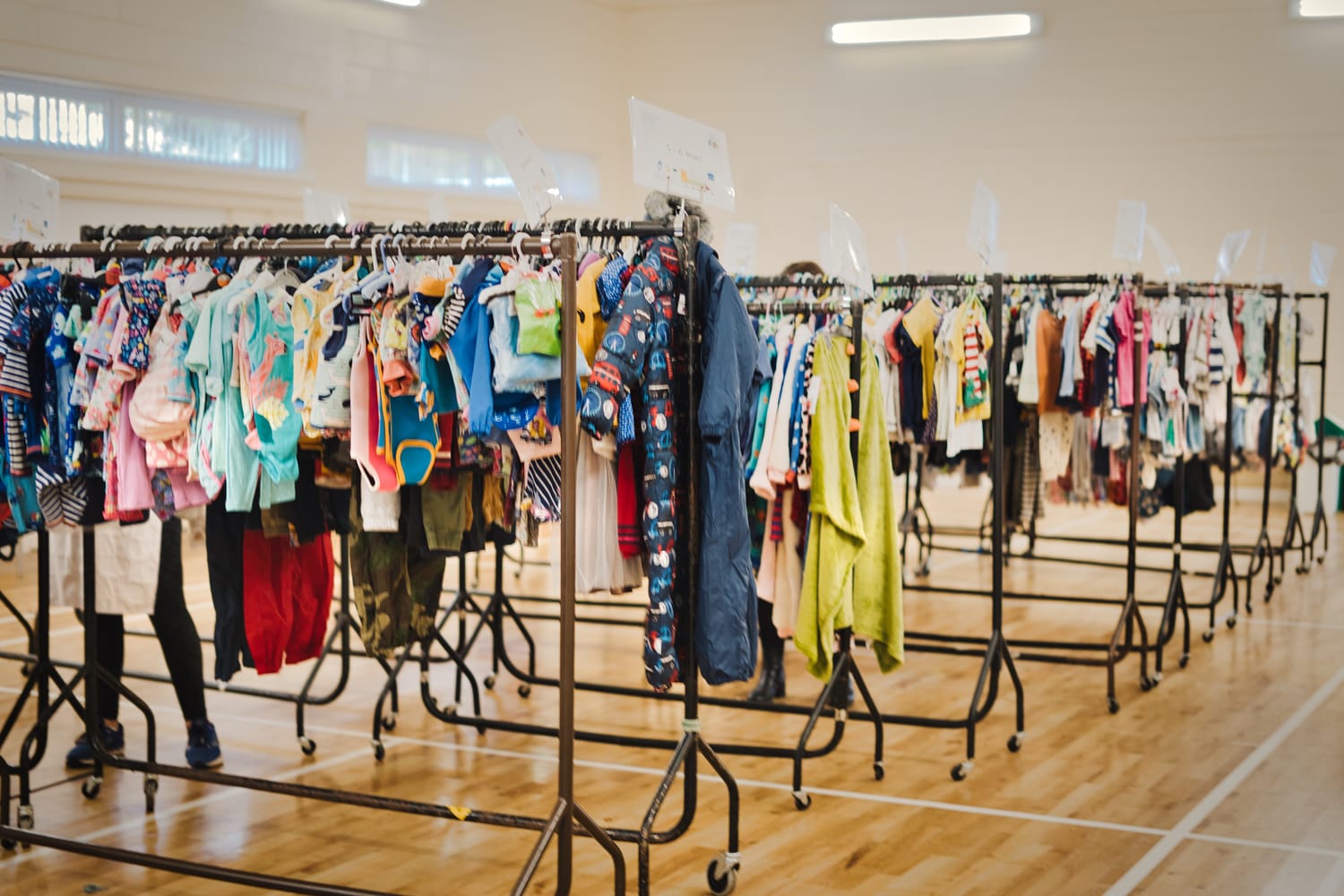 Racks of secondhand clothes for babies and young children at an NCT Nearly New Sale
