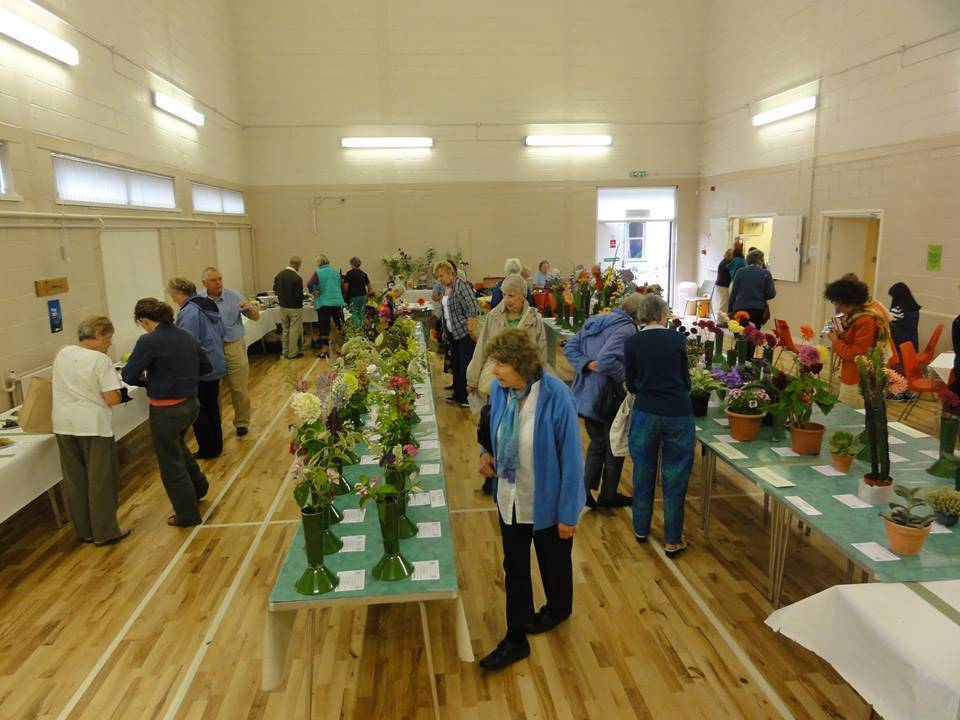 People looking at craft and other items on display in the main hall at Badger Farm Community Centre.