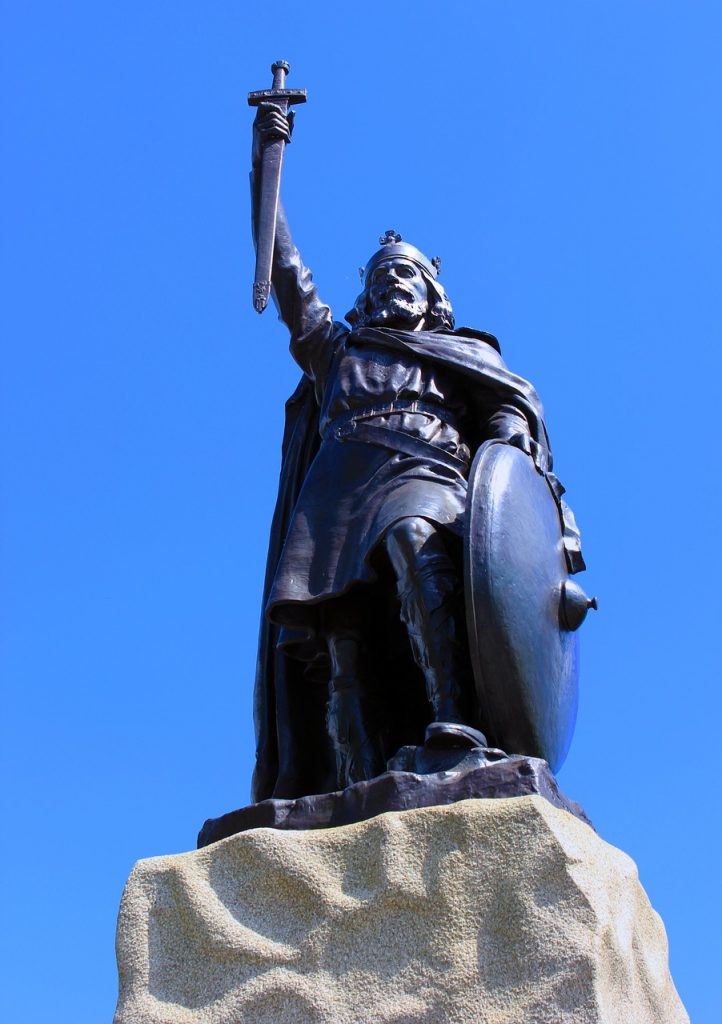 The statue of King Alfred in Winchester, highlighted against a blue sky.