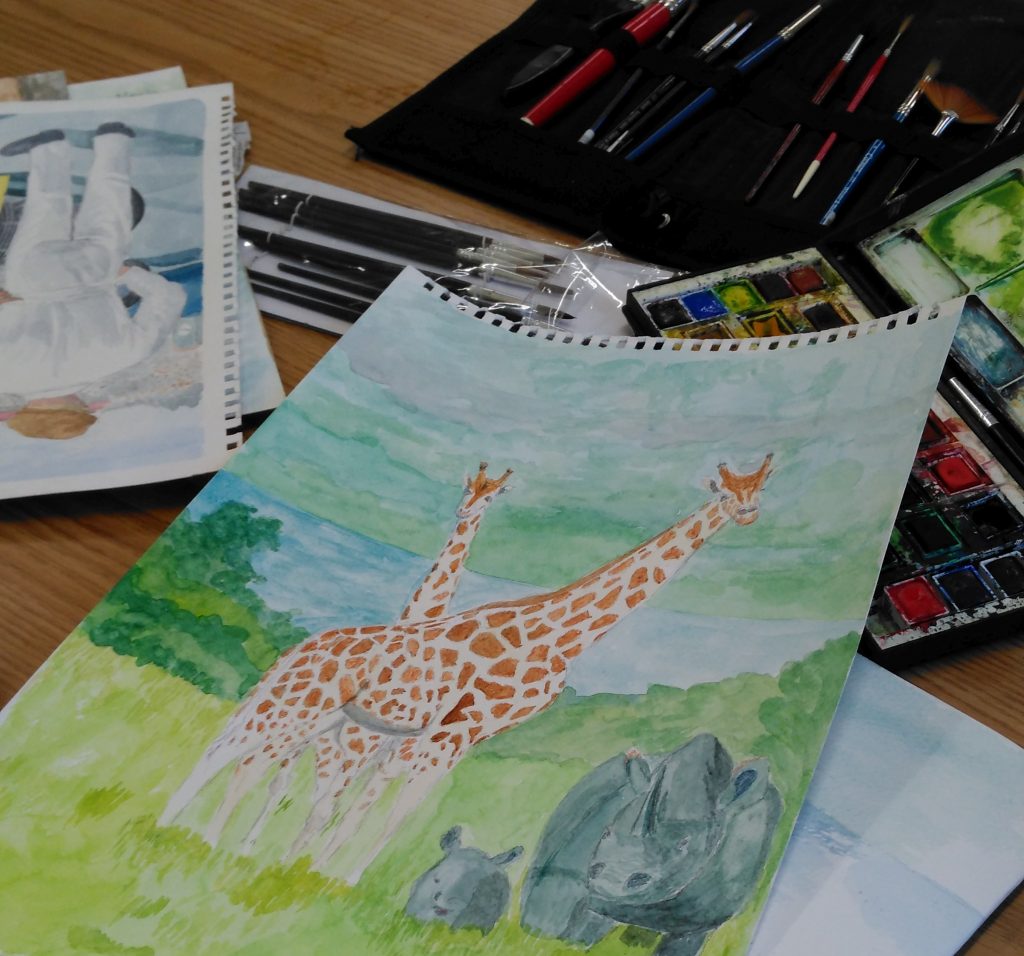 A few watercolour paintings, with a paintbox and brushes.