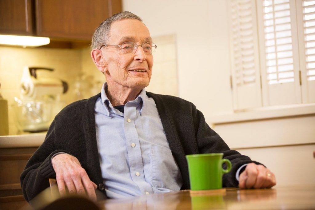 Male Client sitting alone smiling